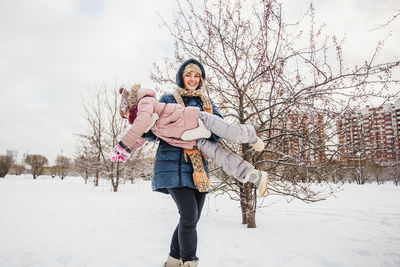 Portrait of woman on snow covered field