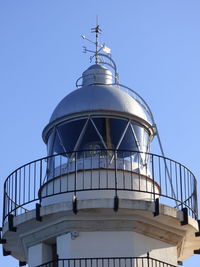 Low angle view of lighthouse against clear blue sky