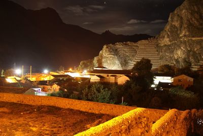 Illuminated city against sky at night