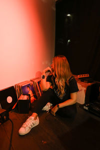 Woman playing guitar at home