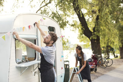 Owners working outside food truck on street