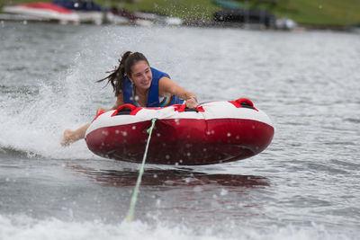 Portrait of woman splashing water in boat