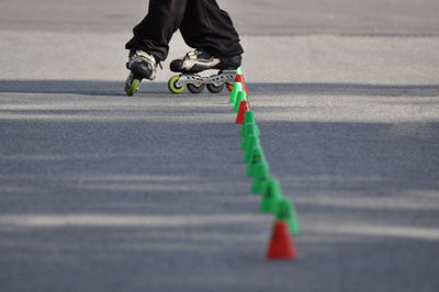 Low section of person skating on road