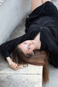 Portrait of beautiful woman against wall