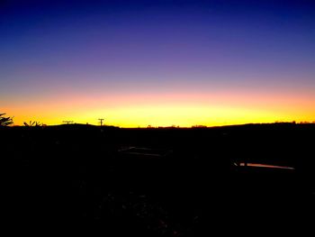 Silhouette landscape against sky during sunset