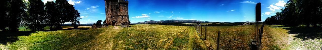 Panoramic shot of trees on field against sky