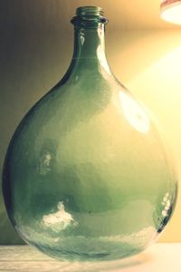 Close-up of bottle in glass on table