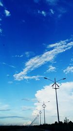 Low angle view of wind turbine against blue sky