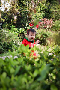 Portrait of cute girl standing amidst plants