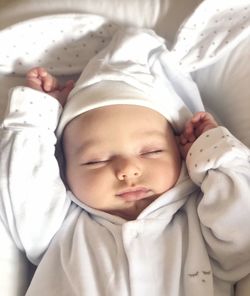 High angle view of cute baby boy sleeping on bed