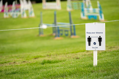 Close-up of information sign on field