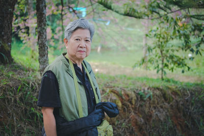 Portrait of woman standing in forest