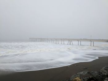 Scenic view of beach against clear sky