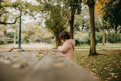 Rear view of woman sitting in park