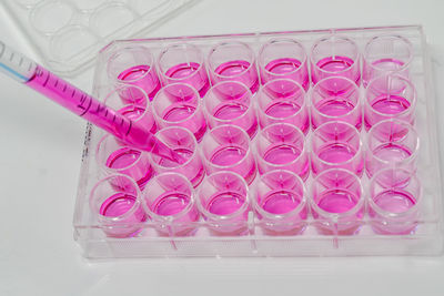 High angle view of pink glass on table