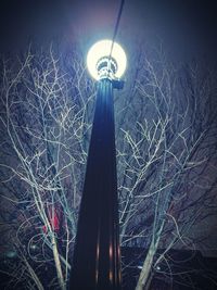 Low angle view of illuminated lights against sky at night