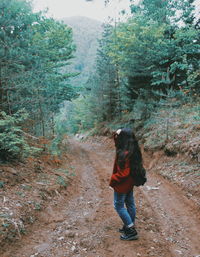 Full length of woman standing on dirt road