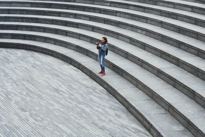 High angle view of woman standing on steps