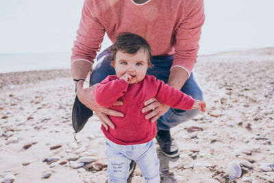 Portrait of daughter and father on beach