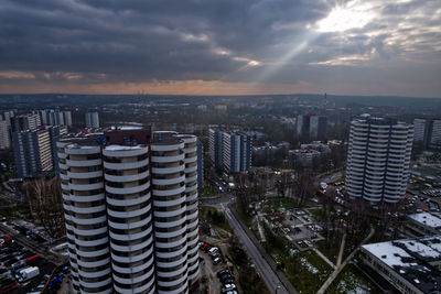 High angle view of modern buildings against sky during sunset