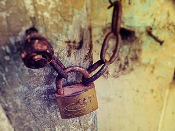 Close-up of padlock hanging on metal