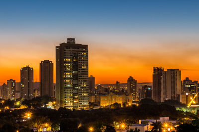 View of city lit up at sunset