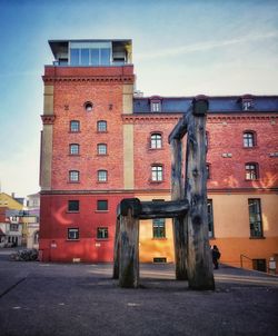 Old building by street against sky at dusk