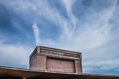 Low angle view of building against cloudy sky