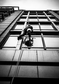 Low angle view of window washer on rope