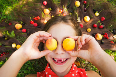 Portrait of happy girl holding apple