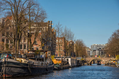 Amsterdam, netherlands, april 2022. the prinsengracht with the westertoren and houseboats.