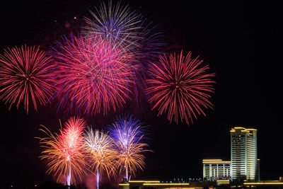 Low angle view of firework display in sky at night