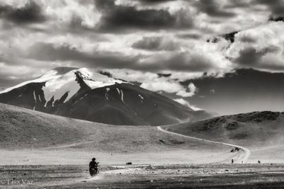 Scenic view of mountains against cloudy sky