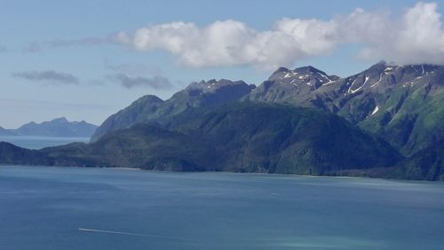 Scenic view of mountains against cloudy sky