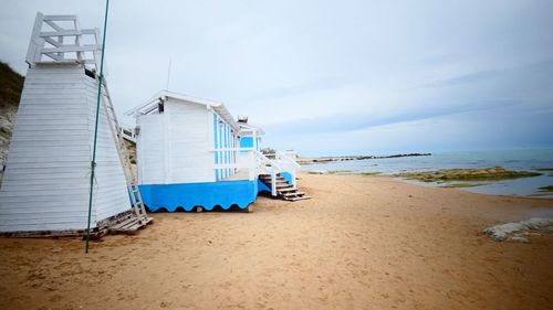 Lifeguard hut on beach against sky