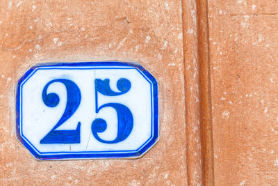 Close-up of number 25 on wall