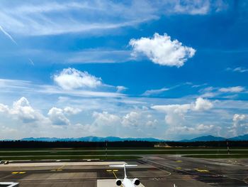 Panoramic view of airport runway against sky