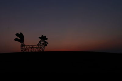 Silhouette plant against clear sky during sunset