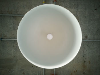 Directly above shot of pendant light on white wall