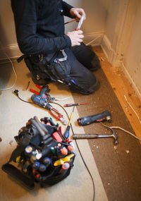 Man working at home, low section