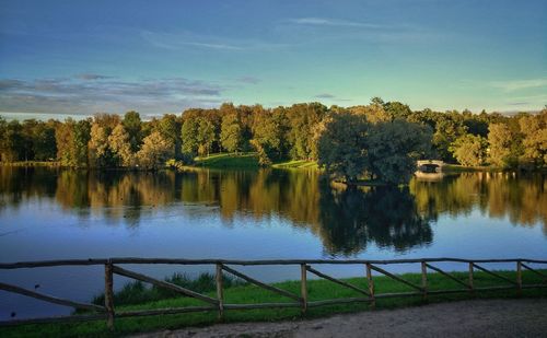 Scenic view of lake by trees against sky