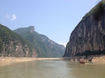 Scenic view of river and mountains against clear sky