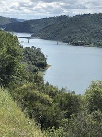 High angle view of river amidst trees against sky