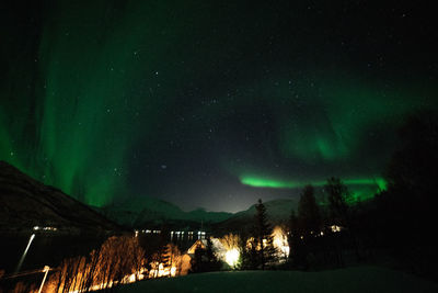 Scenic view of lake against sky at night