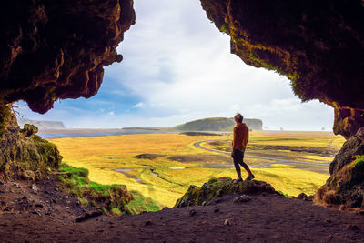 Man standing on land against sky