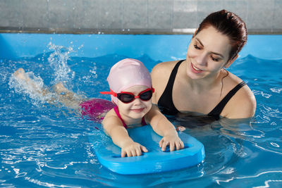 Portrait of woman swimming in pool