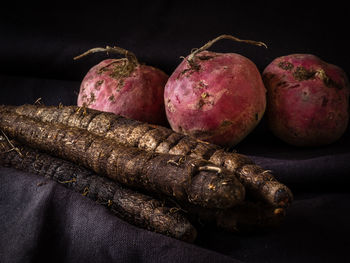 Close-up of black salsify and beets on table