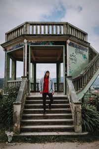 Full length of woman standing on staircase