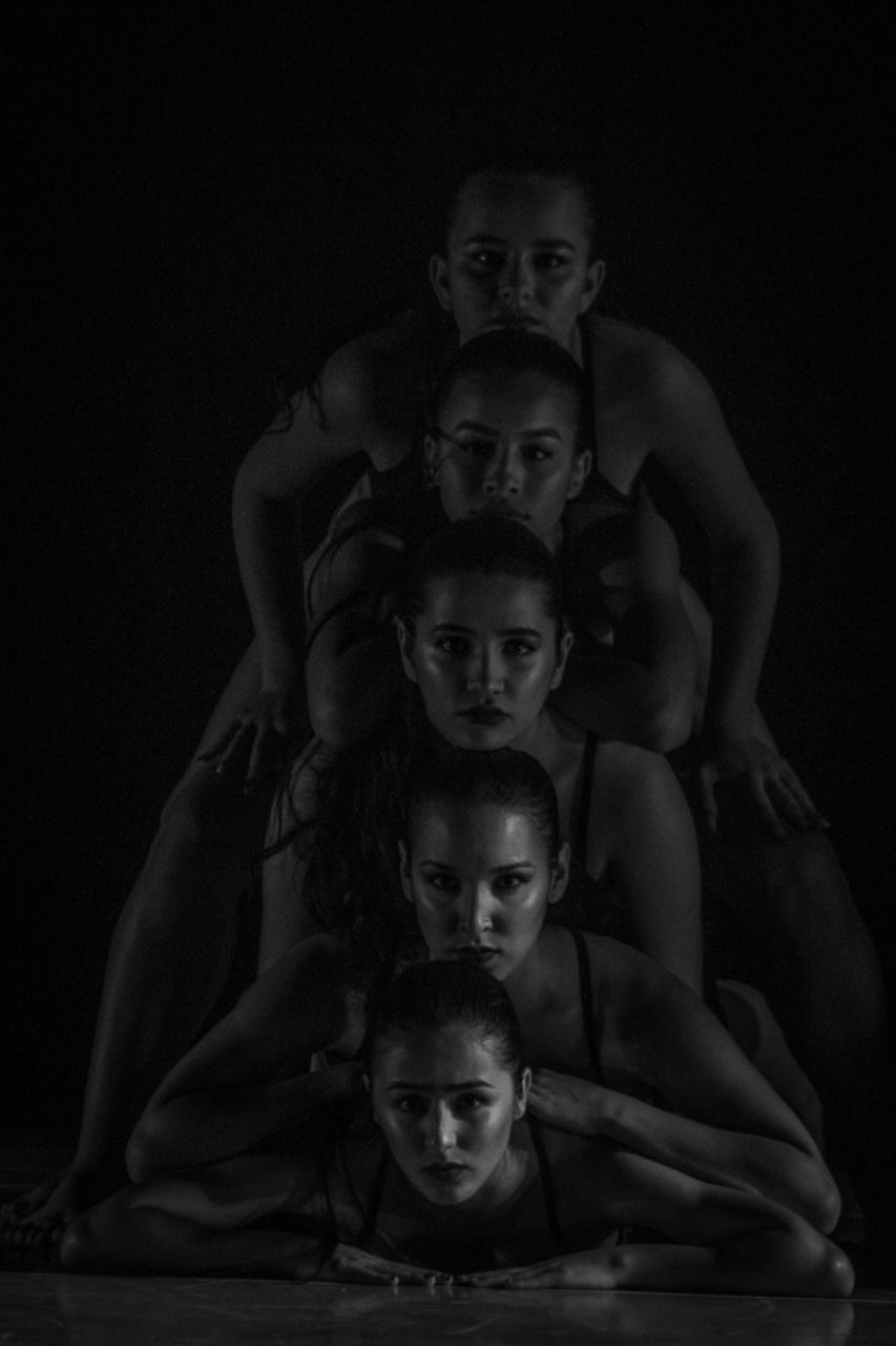 childhood, child, indoors, group of people, females, males, boys, family, togetherness, portrait, lifestyles, men, women, sibling, girls, looking at camera, people, studio shot, mid adult, sister, black background, son, dark