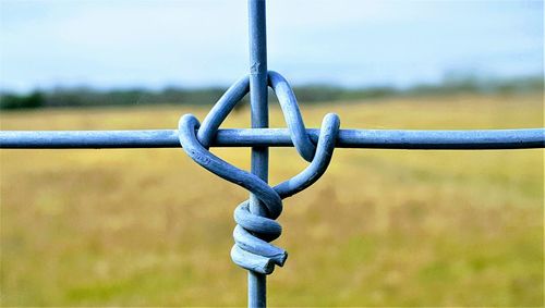 Close-up of metal against sky